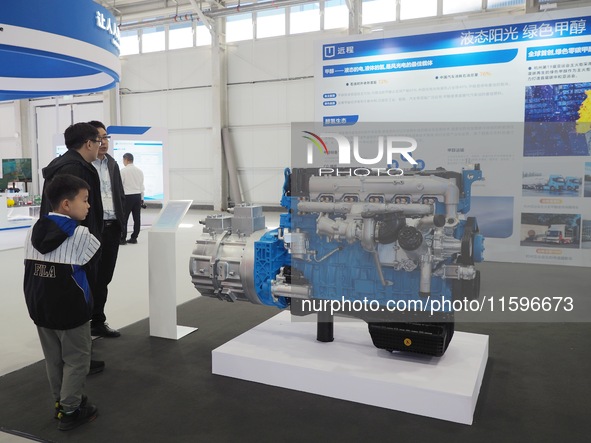 Visitors view a ''methanol engine'' at the 16th International Transportation Technology and Equipment Exhibition in Beijing, China, on Septe...