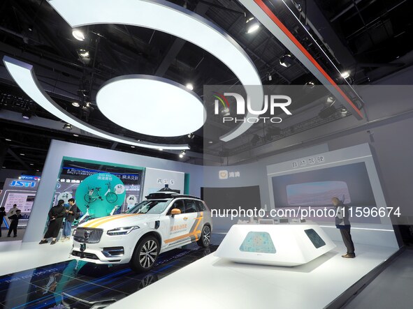 Visitors visit the booth of Didi at the 16th International Transportation Technology and Equipment Exhibition in Beijing, China, on Septembe...