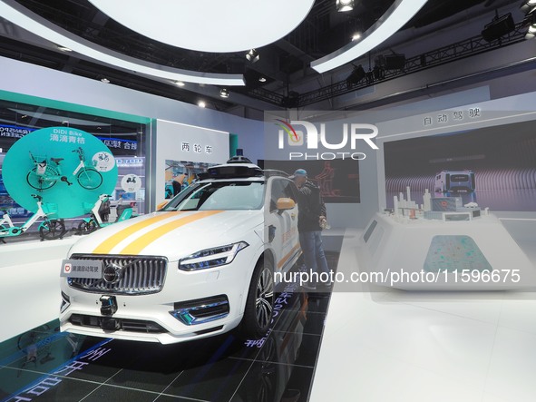 Visitors view a ''Didi self-driving car'' at the 16th International Transportation Technology and Equipment Exhibition in Beijing, China, on...