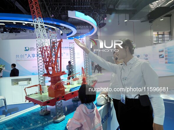 Visitors visit the ''Daqiaohaifeng'' wind power installation ship at the 16th International Transportation Technology and Equipment Exhibiti...