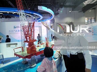 Visitors visit the ''Daqiaohaifeng'' wind power installation ship at the 16th International Transportation Technology and Equipment Exhibiti...