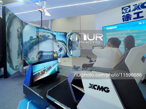 Visitors experience the ''5G smart cockpit'' at the 16th International Transportation Technology and Equipment Exhibition in Beijing, China,...