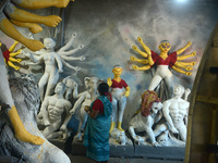 Male and female artists work on a semi-finished idol of the Hindu goddess 'Durga' in Siliguri, India, on September 22, 2024. (