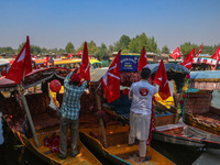 Supporters of the Jammu and Kashmir National Conference party (JKNC) install the party's flag on boats during an election rally at Dal Lake,...