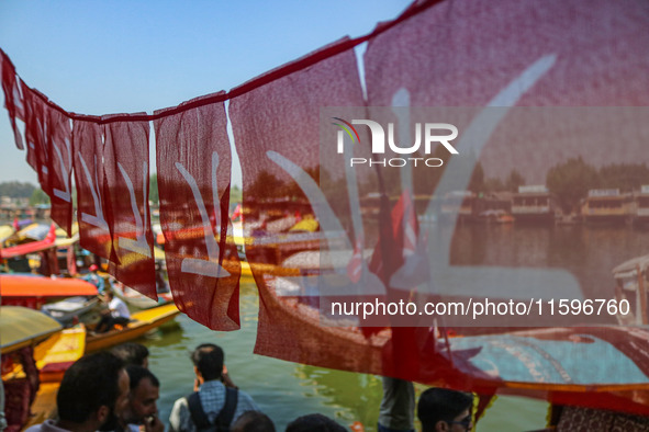 Supporters of the Jammu and Kashmir National Conference party (JKNC) participate in an election rally at Dal Lake, ahead of the second phase...