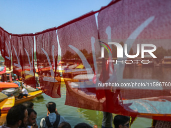 Supporters of the Jammu and Kashmir National Conference party (JKNC) participate in an election rally at Dal Lake, ahead of the second phase...