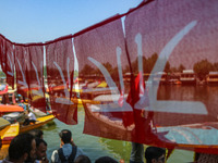 Supporters of the Jammu and Kashmir National Conference party (JKNC) participate in an election rally at Dal Lake, ahead of the second phase...