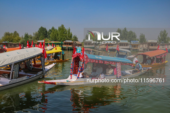 Supporters of the Jammu and Kashmir National Conference party (JKNC) participate in an election rally at Dal Lake, ahead of the second phase...