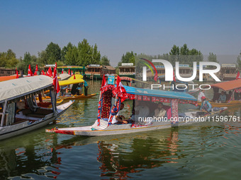 Supporters of the Jammu and Kashmir National Conference party (JKNC) participate in an election rally at Dal Lake, ahead of the second phase...