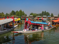 Supporters of the Jammu and Kashmir National Conference party (JKNC) participate in an election rally at Dal Lake, ahead of the second phase...