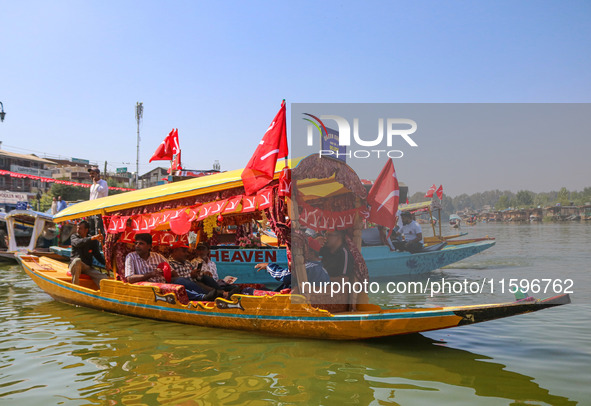 Supporters of the Jammu and Kashmir National Conference party (JKNC) participate in an election rally at Dal Lake, ahead of the second phase...