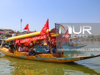 Supporters of the Jammu and Kashmir National Conference party (JKNC) participate in an election rally at Dal Lake, ahead of the second phase...