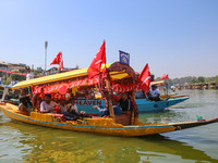 Supporters of the Jammu and Kashmir National Conference party (JKNC) participate in an election rally at Dal Lake, ahead of the second phase...