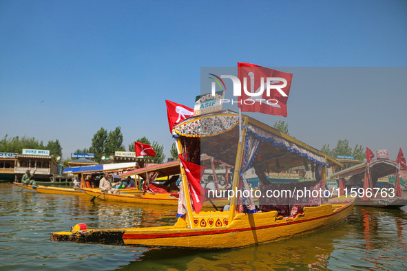 Supporters of the Jammu and Kashmir National Conference party (JKNC) participate in an election rally at Dal Lake, ahead of the second phase...