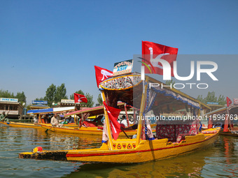 Supporters of the Jammu and Kashmir National Conference party (JKNC) participate in an election rally at Dal Lake, ahead of the second phase...