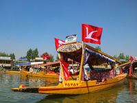 Supporters of the Jammu and Kashmir National Conference party (JKNC) participate in an election rally at Dal Lake, ahead of the second phase...