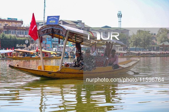 Indian security personnel patrol in a boat during an election rally at Dal Lake, ahead of the second phase of voting during the assembly ele...