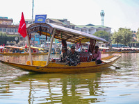 Indian security personnel patrol in a boat during an election rally at Dal Lake, ahead of the second phase of voting during the assembly ele...