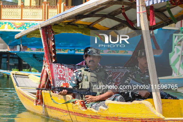 Indian security personnel patrol in a boat during an election rally at Dal Lake, ahead of the second phase of voting during the assembly ele...