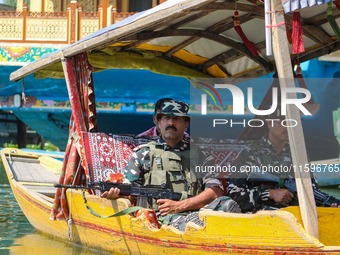 Indian security personnel patrol in a boat during an election rally at Dal Lake, ahead of the second phase of voting during the assembly ele...