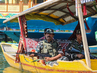 Indian security personnel patrol in a boat during an election rally at Dal Lake, ahead of the second phase of voting during the assembly ele...