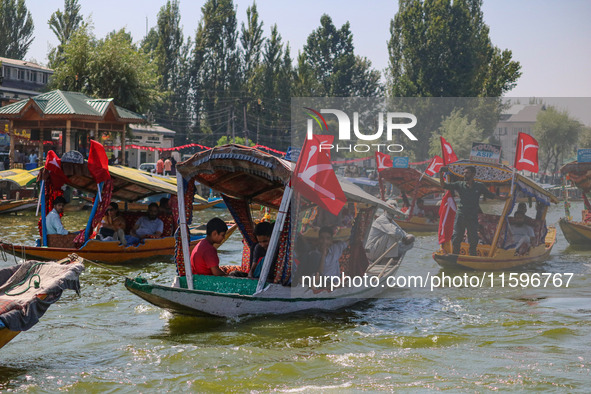 Supporters of the Jammu and Kashmir National Conference party (JKNC) participate in an election rally at Dal Lake, ahead of the second phase...