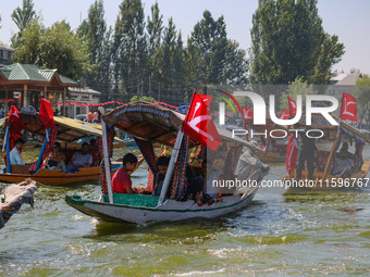 Supporters of the Jammu and Kashmir National Conference party (JKNC) participate in an election rally at Dal Lake, ahead of the second phase...