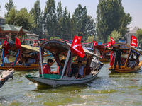 Supporters of the Jammu and Kashmir National Conference party (JKNC) participate in an election rally at Dal Lake, ahead of the second phase...