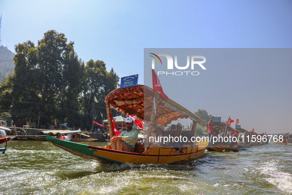 Supporters of the Jammu and Kashmir National Conference party (JKNC) participate in an election rally at Dal Lake, ahead of the second phase...