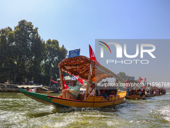 Supporters of the Jammu and Kashmir National Conference party (JKNC) participate in an election rally at Dal Lake, ahead of the second phase...