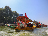 Supporters of the Jammu and Kashmir National Conference party (JKNC) participate in an election rally at Dal Lake, ahead of the second phase...