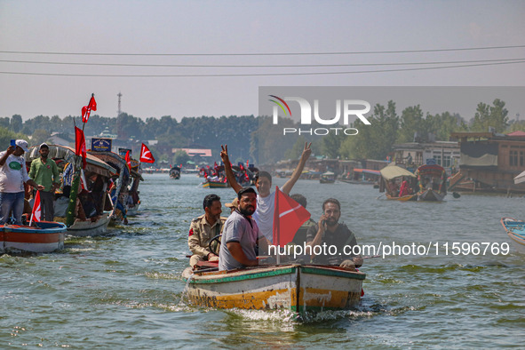 Indian security personnel patrol in a boat during an election rally at Dal Lake, ahead of the second phase of voting during the assembly ele...