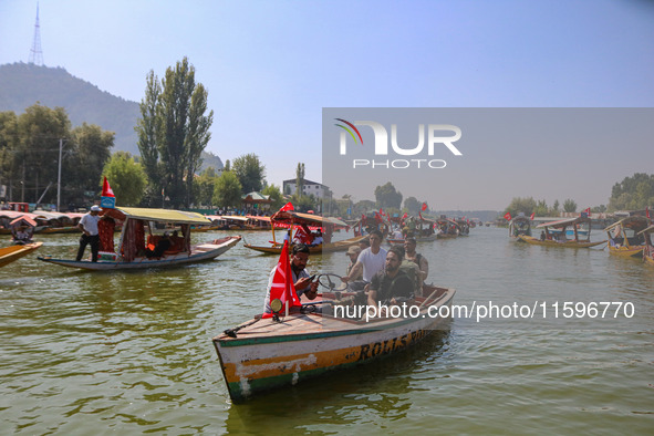 Indian security personnel patrol in a boat during an election rally at Dal Lake, ahead of the second phase of voting during the assembly ele...