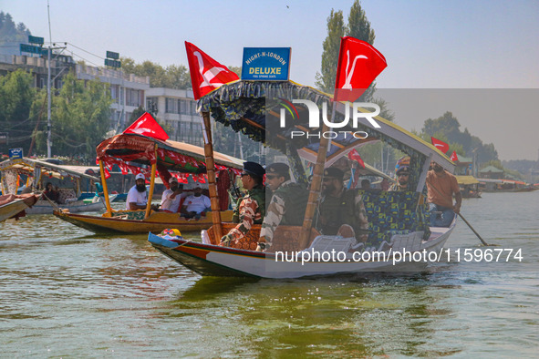 Indian security personnel patrol in a boat during an election rally at Dal Lake, ahead of the second phase of voting during the assembly ele...