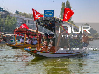 Indian security personnel patrol in a boat during an election rally at Dal Lake, ahead of the second phase of voting during the assembly ele...