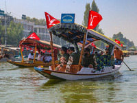 Indian security personnel patrol in a boat during an election rally at Dal Lake, ahead of the second phase of voting during the assembly ele...