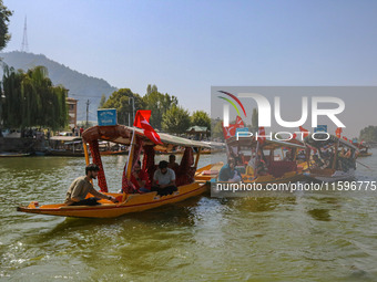 Supporters of the Jammu and Kashmir National Conference party (JKNC) participate in an election rally at Dal Lake, ahead of the second phase...