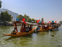 Supporters of the Jammu and Kashmir National Conference party (JKNC) participate in an election rally at Dal Lake, ahead of the second phase...