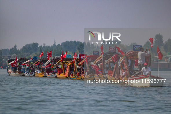 Supporters of the Jammu and Kashmir National Conference party (JKNC) participate in an election rally at Dal Lake, ahead of the second phase...