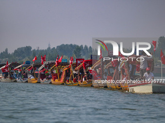 Supporters of the Jammu and Kashmir National Conference party (JKNC) participate in an election rally at Dal Lake, ahead of the second phase...