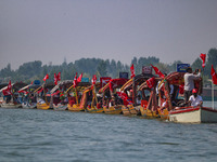 Supporters of the Jammu and Kashmir National Conference party (JKNC) participate in an election rally at Dal Lake, ahead of the second phase...