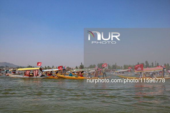 Supporters of the Jammu and Kashmir National Conference party (JKNC) participate in an election rally at Dal Lake, ahead of the second phase...