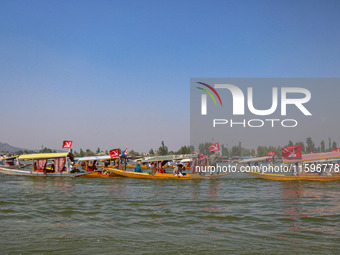 Supporters of the Jammu and Kashmir National Conference party (JKNC) participate in an election rally at Dal Lake, ahead of the second phase...