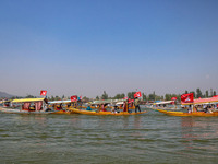 Supporters of the Jammu and Kashmir National Conference party (JKNC) participate in an election rally at Dal Lake, ahead of the second phase...