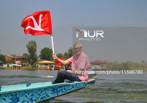 Omar Abdullah, the leader of Jammu and Kashmir National Conference (JKNC), holds his party's flag during an election rally at Dal Lake, ahea...