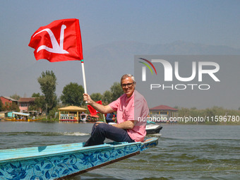 Omar Abdullah, the leader of Jammu and Kashmir National Conference (JKNC), holds his party's flag during an election rally at Dal Lake, ahea...