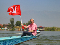 Omar Abdullah, the leader of Jammu and Kashmir National Conference (JKNC), holds his party's flag during an election rally at Dal Lake, ahea...