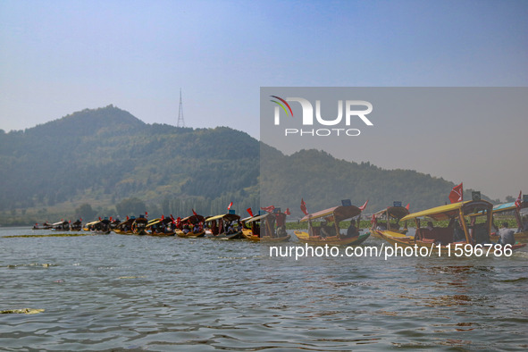 Supporters of the Jammu and Kashmir National Conference party (JKNC) participate in an election rally at Dal Lake, ahead of the second phase...