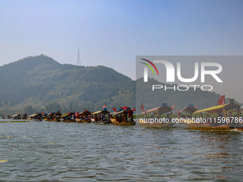 Supporters of the Jammu and Kashmir National Conference party (JKNC) participate in an election rally at Dal Lake, ahead of the second phase...