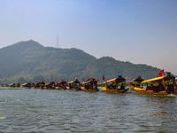 Supporters of the Jammu and Kashmir National Conference party (JKNC) participate in an election rally at Dal Lake, ahead of the second phase...